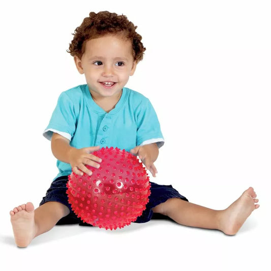 A baby playing with an Edushape 18cm See Me Sensory Ball.