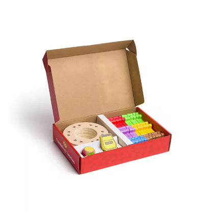 A red box filled with lots of assorted items including the Bigjigs Tumbling Teddies Balance Game from Bigjigs.
