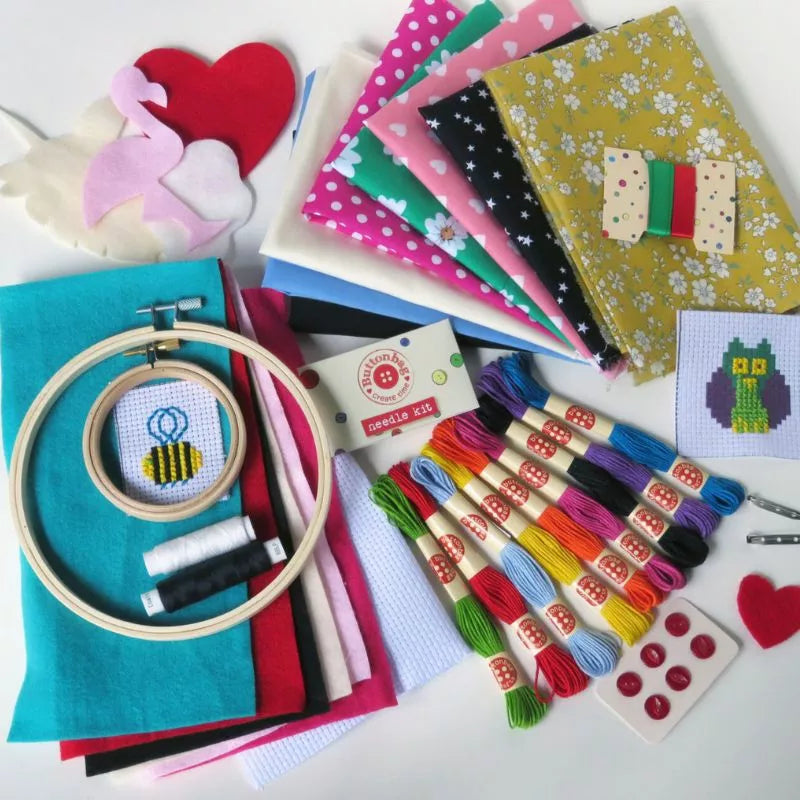A Buttonbag Bumper Sewing and Embroidery Bumper Kit with an embroidery hoop and other items.