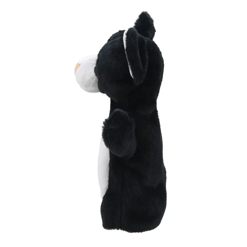 A plush puppet from the ECO Puppet Buddies Black & White Cat Hand Puppet collection, depicting a standing black and white cat with a raised paw and upright ears, shown in profile against a white background.