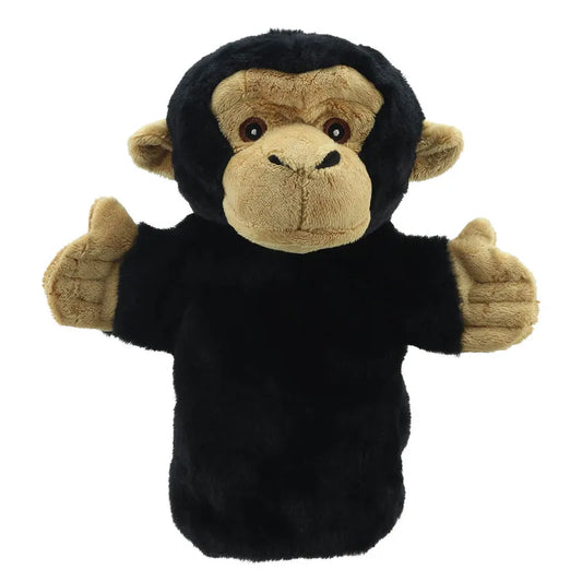 A ECO Puppet Buddies Chimp Hand Puppet in a plush toy form, with a black body and beige face and hands, standing with arms stretched out to the sides.
