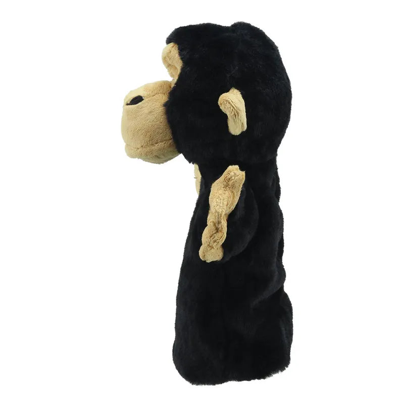Side view of a black and cream-colored ECO Puppet Buddies Chimp Hand Puppet standing upright, with a prominent snout and floppy ears, isolated on a white background.