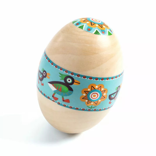 A Djeco Animambo Maraca with colorful designs on it, used as a maraca.