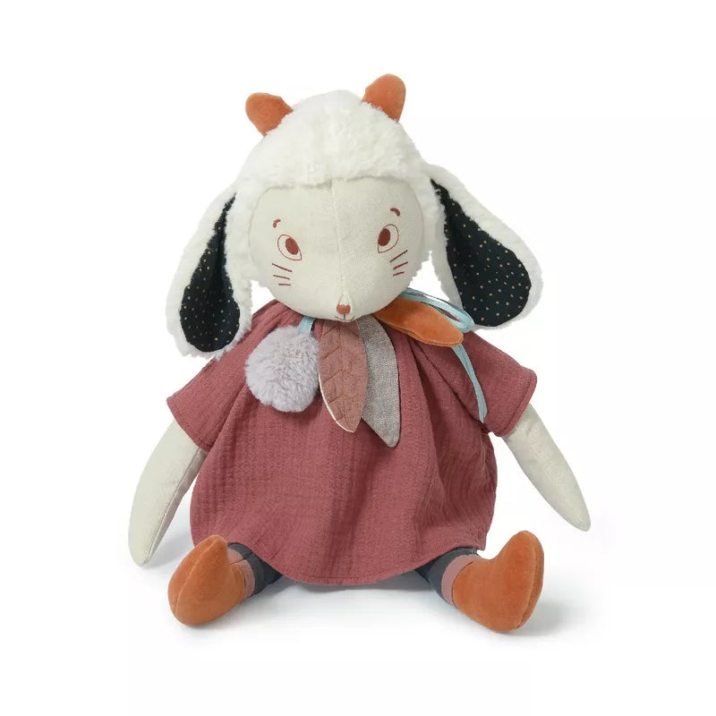 A Moulin Roty Fenouil the large Sheep wearing a pink dress.