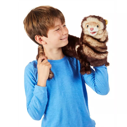A young boy holding a Folkmanis Puppets Ferret puppet.