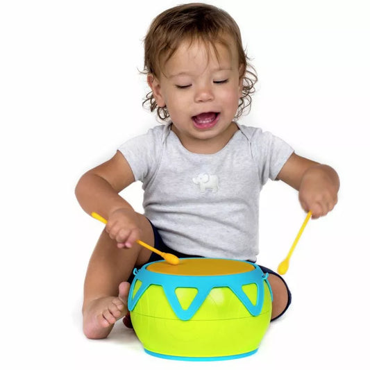 A baby playing with a Halilit Super Drum.