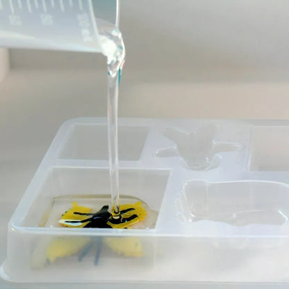 A Sentosphere Resin Workshop with a plastic tray featuring a yellow and black bee in it, designed for children.