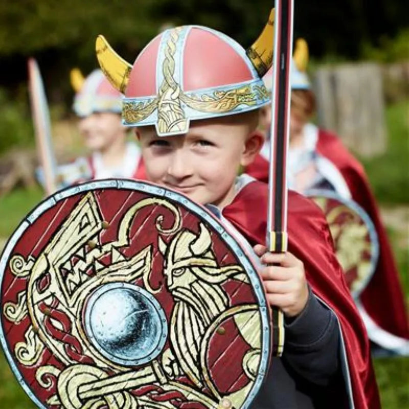 A group of children engaged in imaginative play as vikings, holding Liontouch Viking Shields.