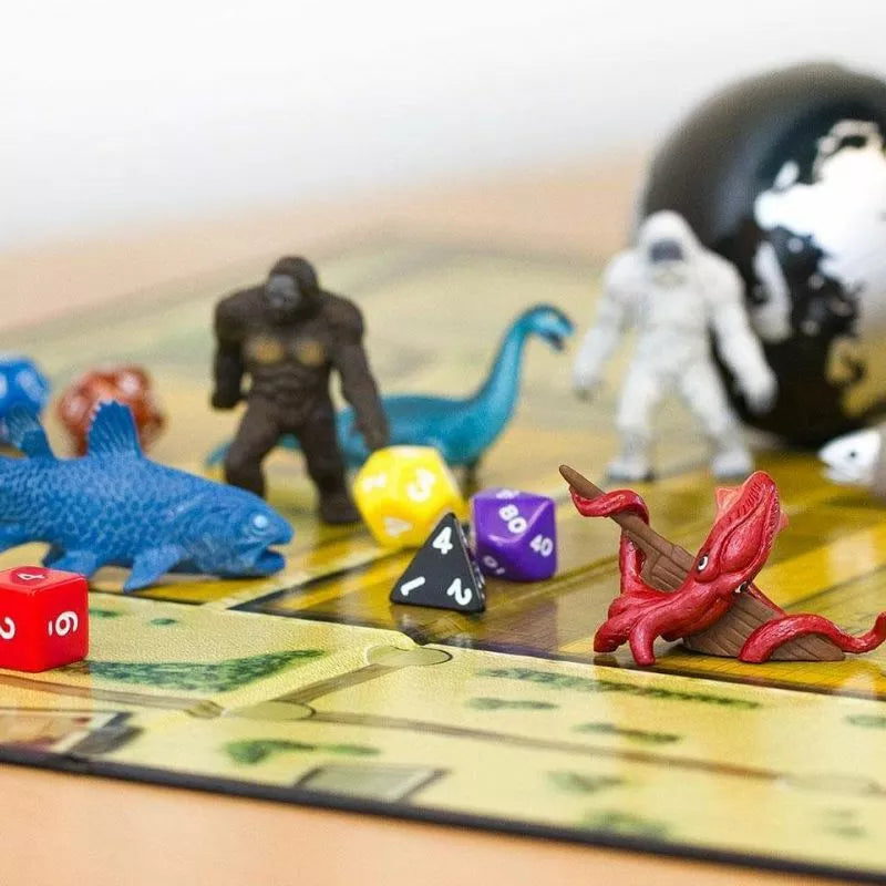 A folklore-themed board game featuring TOOBS® Figurines Cryptozoology, played with dice on a table.