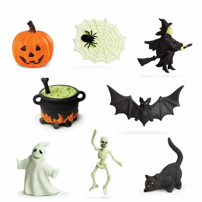 A collage of Halloween-themed TOOBS® Figurines Halloween Glow in the Dark featuring a pumpkin, a spider on a web, a witch flying on a broom, a cauldron, a bat.