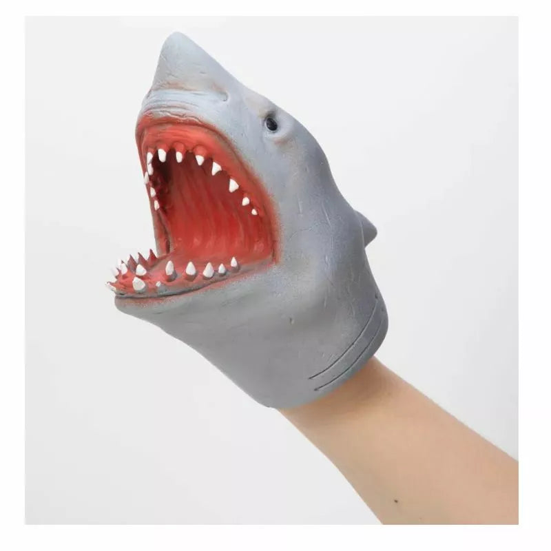 A hand holding a Schylling Shark Hand Puppet with its mouth open.