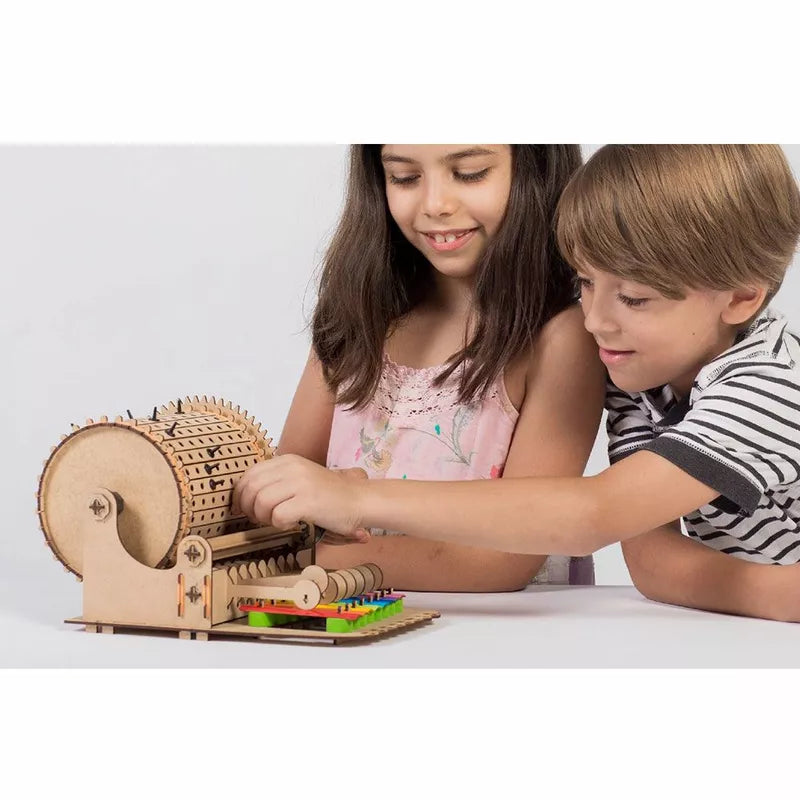 Two children playing with a Smartivity Music Machine toy.