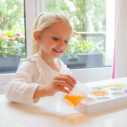 A little girl is playing with a Sentosphere Soaps and Scents DIY kit for soap making.