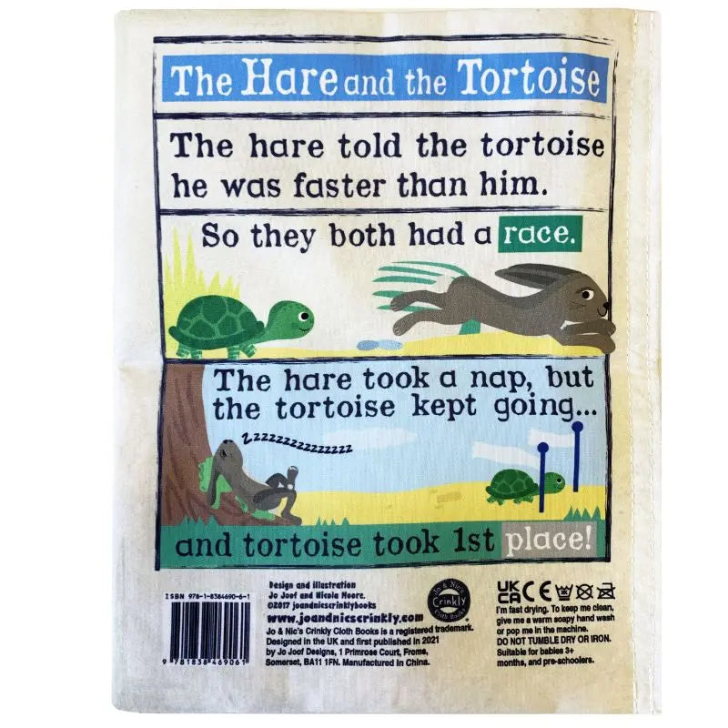 An illustrated Crinkly Cloth Book Three Little Tales page features "The Hare and the Tortoise" with playful race scenes. This sensory baby book narrates the classic fable’s moral through engaging cartoon images and text.