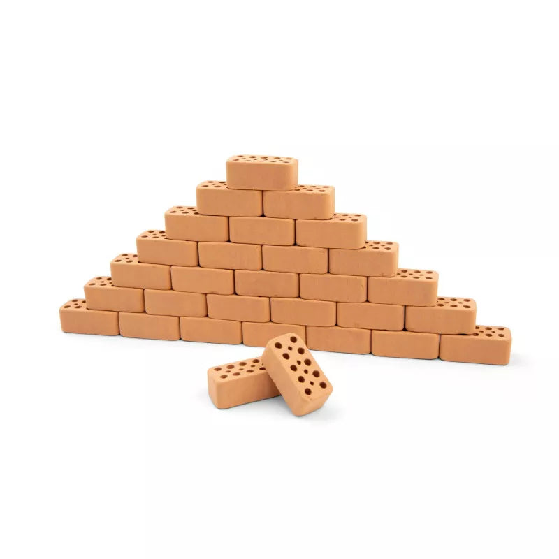 A Teifoc Bricks 32 pieces pyramid with a pair of pegs in front of it.
