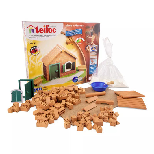 A set of Teifoc Brick Construction Starter Box – DAMAGED PACKAGING, including terracotta bricks, to build a wooden house.