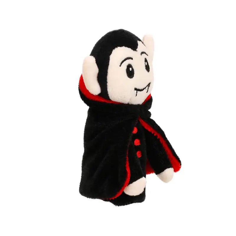Vampire Finger Puppet Decoration featuring a cartoon vampire with a black cape, red trim, white fangs, and a cheerful expression—ideal for bringing some spooky fun to your Halloween decorations. Displayed against a plain white background.