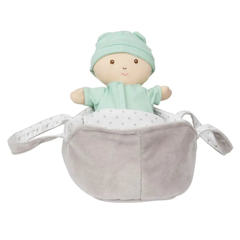 The Wilberry Baby Doll in Green Outfit comes with a plush light gray and white basket featuring polka dot lining, two handles, and a blanket.