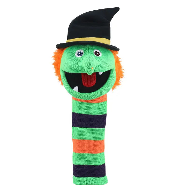The Puppet Company Sockette Wilma is an eco-friendly hand puppet with orange hair, googly eyes, a long nose, a striped green, orange, and purple body, plus a black witch hat with a yellow band and an open mouth.
