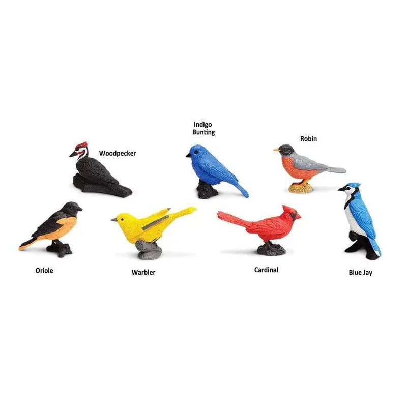 A collection of seven TOOB® Figurines Backyard Birds, labeled individually as woodpecker, oriole, indigo bunting, robin, cardinal, and blue jay, arranged against a plain background