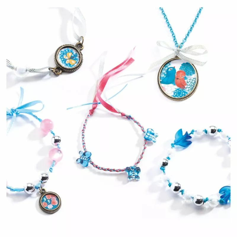 A group of Djeco Beads and birds bracelets with charms on them.