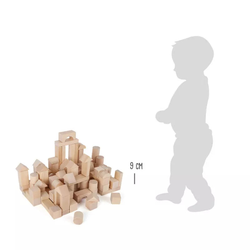A small child standing next to a pile of Wooden Blocks Natural 100.