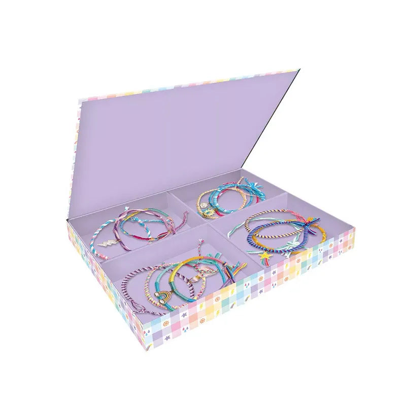 The Janod 30 Rainbow Wrap Bracelets To Make kit includes an open pastel-colored box with various multicolored friendship bracelets, neatly arranged in four compartments. Each bracelet features different designs and patterns, including braided and beaded styles. The inside lid of the box is plain lavender, completing this creative kit brimming with rainbow colors.