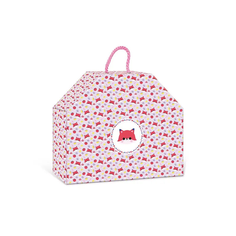 A colorful, house-shaped gift box with a pink and white twisted rope handle, adorned with a playful pattern of small candies and featuring an illustration of a red fox face in a white circle on the front, makes it perfect for holding the Janod 4 Pieces Of Wooden Jewellery To Make Pretty Forest or other creative toys for kids.