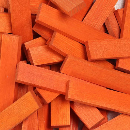 A close-up image of a jumbled collection of red wooden KAPLA® 40 Coloured Planks Orange.