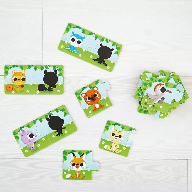 A set of Janod Animals And Their Shadow Puzzles featuring cute animals and their corresponding silhouettes scattered on a white wooden floor.
