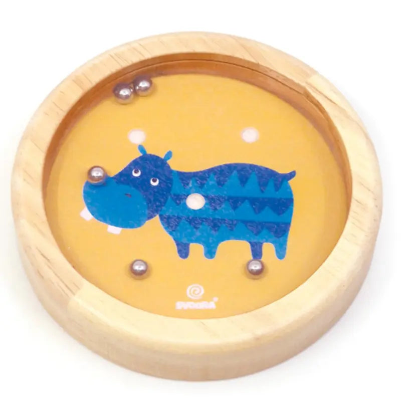 The Wooden Balance Game Hippo is a round wooden maze toy with a yellow background, blue cartoon hippo, and metal balls inside—an ideal fun travel toy.