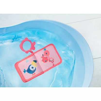 A Lilliputiens Anais Bath Playbook filled with water and a pink tag.