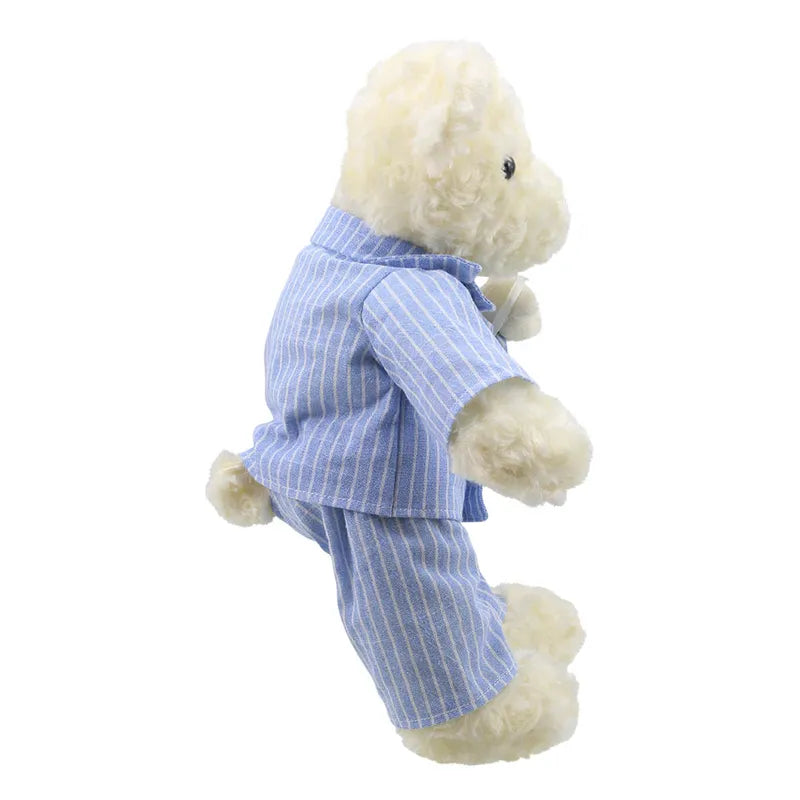 A fluffy, white baby bear viewed from the side, wearing a light blue, striped pajama set. The soft bear is standing on its hind legs with its right arm slightly extended forward. The background is white and plain, making it a perfect birthday present choice for Wilberry Dressed Animal Bedtime Bear Pyjamas.