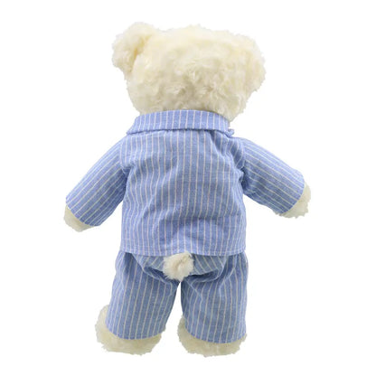 A fluffy baby bear seen from the back, wearing blue and white striped pajamas. The soft bear's outfit covers it from neck to paws and is slightly wrinkled. Its cream-colored fur and tiny rounded tail peek out from under the pajama top, making it an adorable Wilberry Dressed Animal Bedtime Bear Pyjamas.
