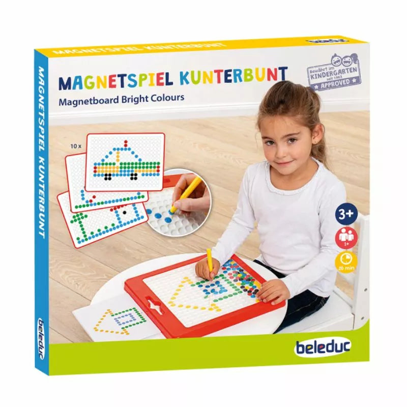 A young girl sitting at a table with Magnetboard "Bright Colours" magnets on it.