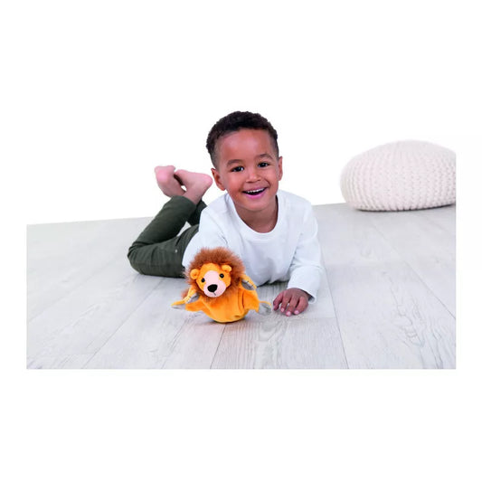 A young boy laying on the floor with a Beleduc Hand Puppet Lion by Beleduc.