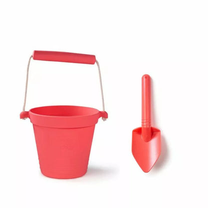 A Bigjigs Coral Pink Eco Bucket & Spade on a white background.