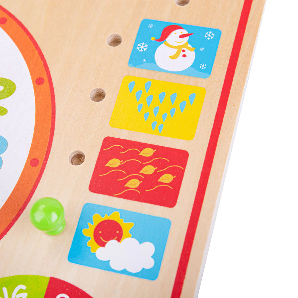 A close up of a wooden board with various stickers, including the Bigjigs Calendar and Clock, from the Bigjigs brand.