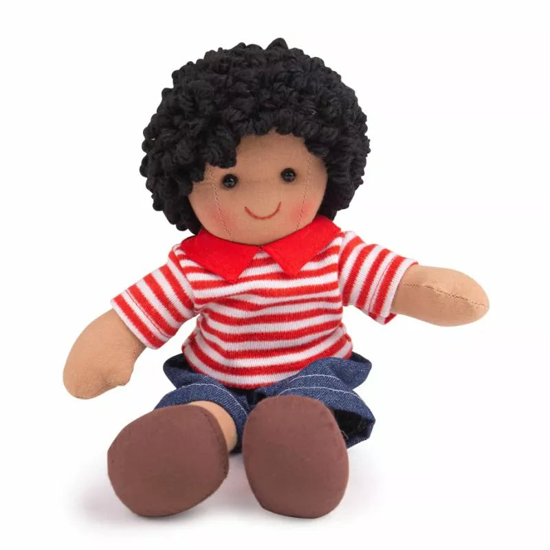 A Bigjigs Otis Small Doll with black hair sitting on a white surface.