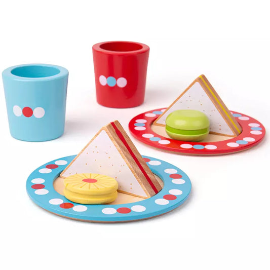 A Bigjigs Tea Time table topped with plates and cups filled with food.