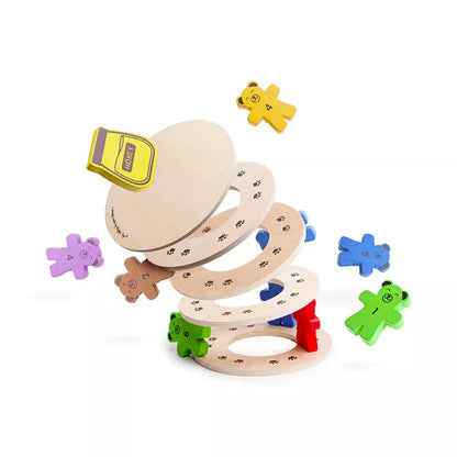 A stack of Bigjigs Tumbling Teddies Balance Game wooden toys with a hat on top of it.
