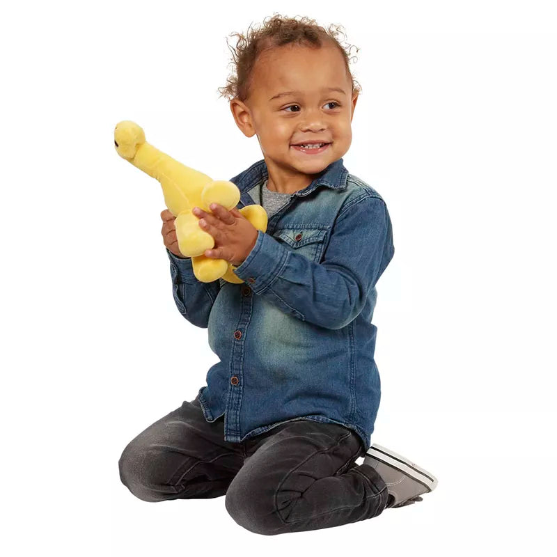 A young boy, dinosaur lover, playing with a yellow stuffed Wilberry Time for Stories – Brontosaurus.