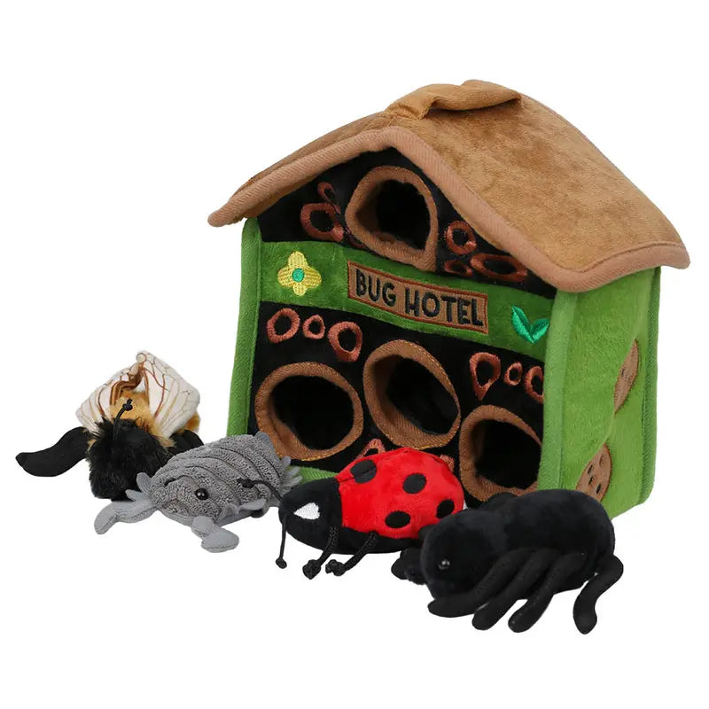 The Puppet Company Hide-Away Bug Hotel is a plush, eco-friendly toy with a brown roof, green walls labeled "Bug Hotel," and includes four finger puppet bugs: a bee, gray bug, ladybug, and black spider.