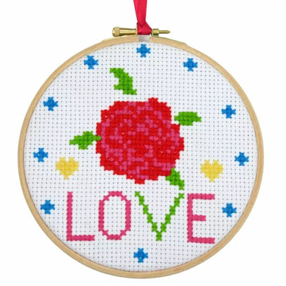 A Buttonbag Bumper Cross Stitch Kit featuring a hoop with a red rose and the word "love".