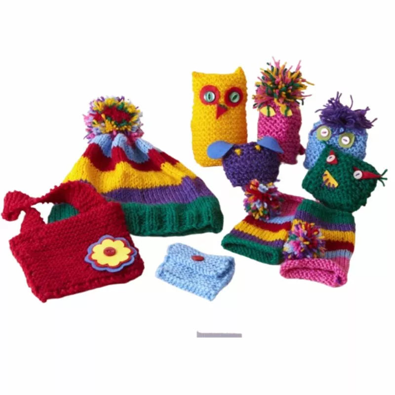 A Buttonbag Learn to Knit Suitcase Kit containing knitted hats, scarves, and mittens.
