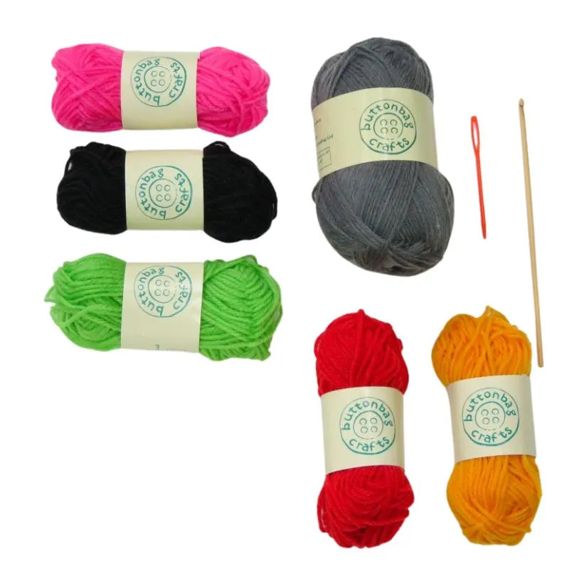 a Buttonbag Crochet a Sausage Dog kit and knitting needles.