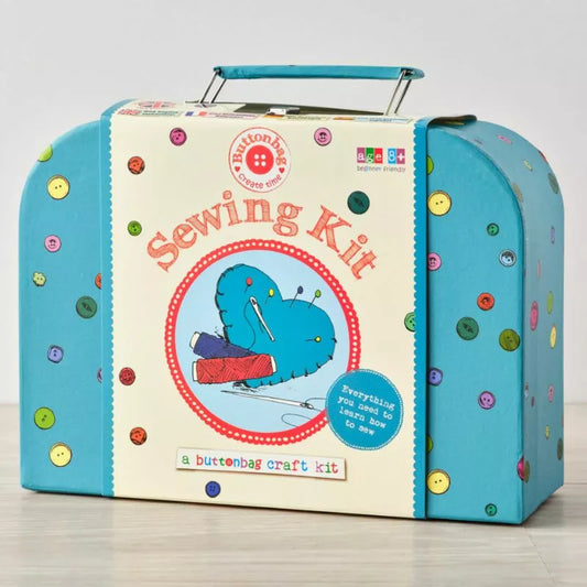 A blue suitcase with a Buttonbag Learn to Sew Suitcase Kit inside, perfect for those looking to learn how to sew.