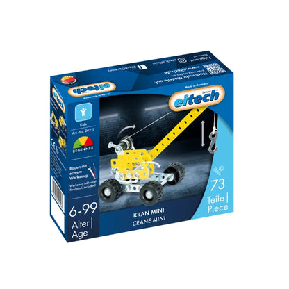 The Eitech Construction Mini Crane comes in a blue box with 73 metal pieces for ages 6 to 99. The packaging shows the assembled model and features both German and English text.