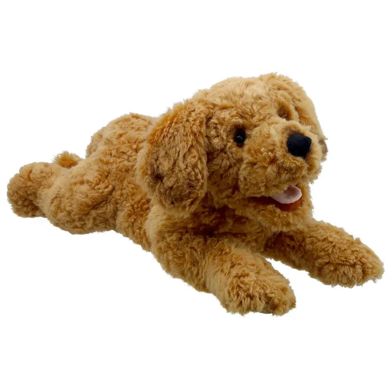 The Cockapoo Hand Puppet - Playful Puppies features a cuddly cockapoo with curly light brown fur, black eyes, and a pink tongue, lying down with front legs stretched forward and back legs extended behind.