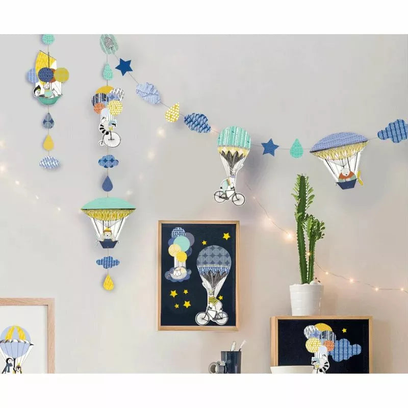 A Creative Kit Polar Expedition decorated room adorned with garlands, balloons, stars, and clouds.
